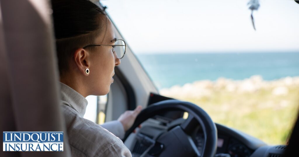 woman driving car during summer Lindquist Insurance