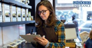 business woman on her tablet in a retail business Lindquist Insurance