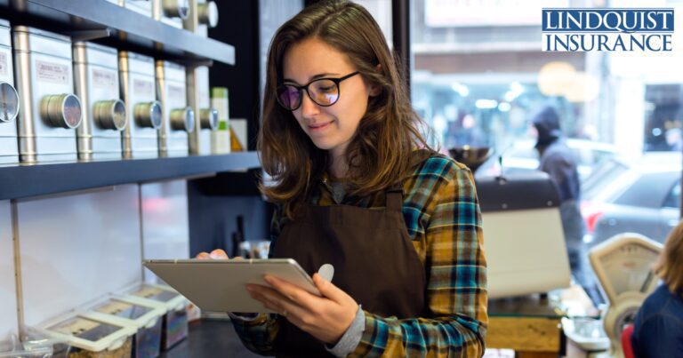 business woman on her tablet in a retail business Lindquist Insurance